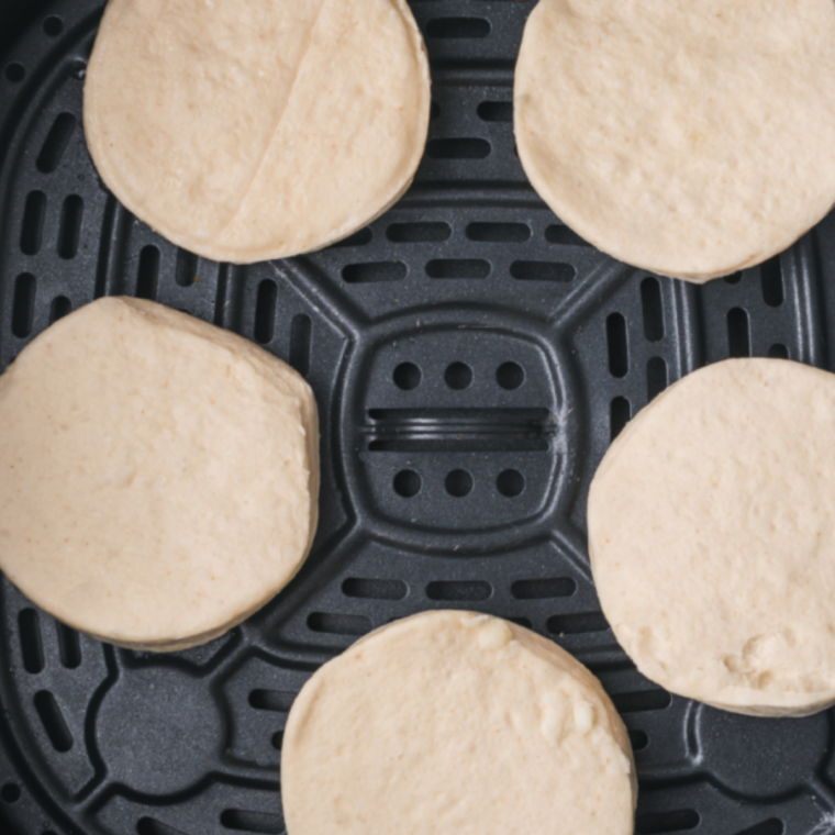 Cooking the biscuits in the air fryer basket.