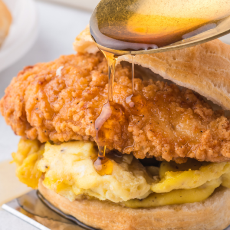 Air Fryer Chicken Biscuit Sandwich with a drizzle of sauce over it.