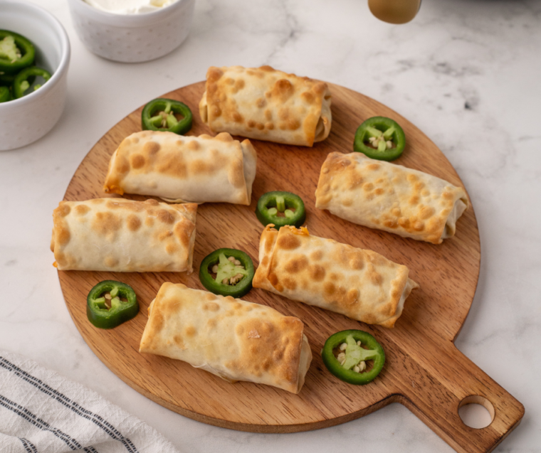 Air Fryer Jalapeno Popper Egg Rolls: Close-up of golden-brown egg rolls with a crispy exterior, showcasing the creamy jalapeno popper filling inside.