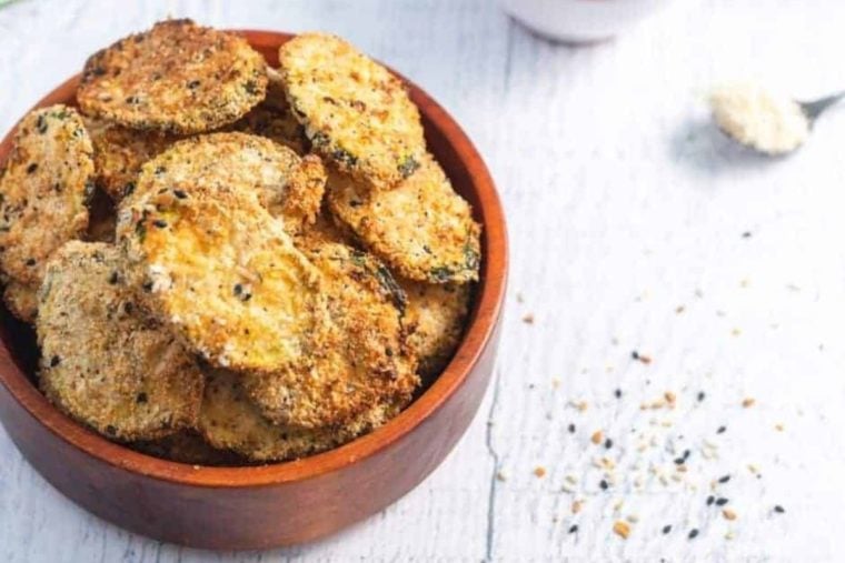 Air fryer zucchini chips in a bowl.