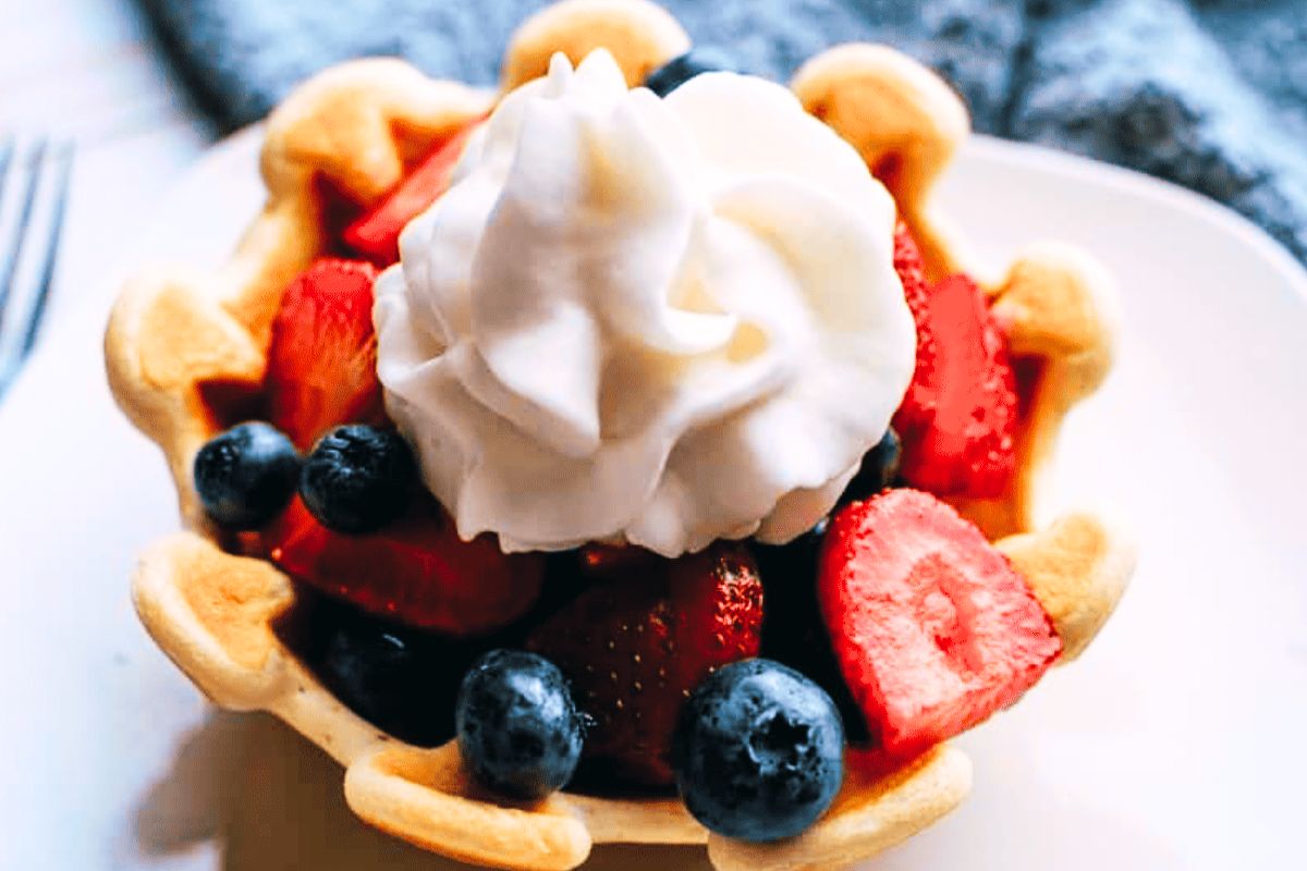 An air fryer waffle bowl filled with fruit.
