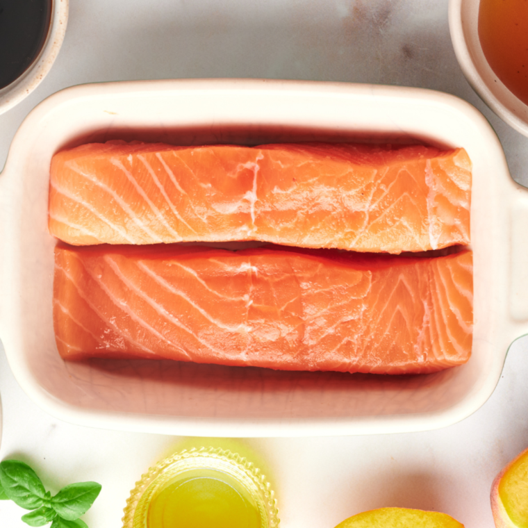 overhead closeup: two salmon filets in a baking dish before air frying
