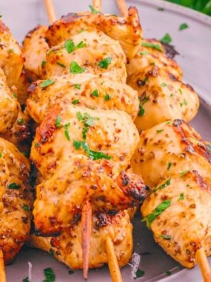 Greek chicken skewers on a plate.