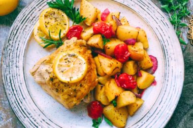 Roasted potatoes and tomatoes on a plate.