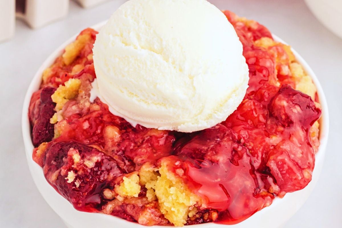 Strawberry dump cake in a bowl.
