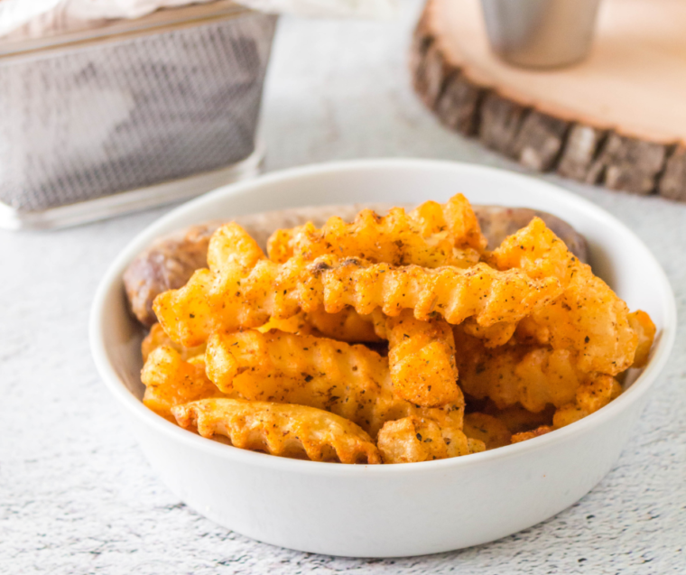 Plate of crispy Copycat Popeyes Cajun Fries seasoned with spices.