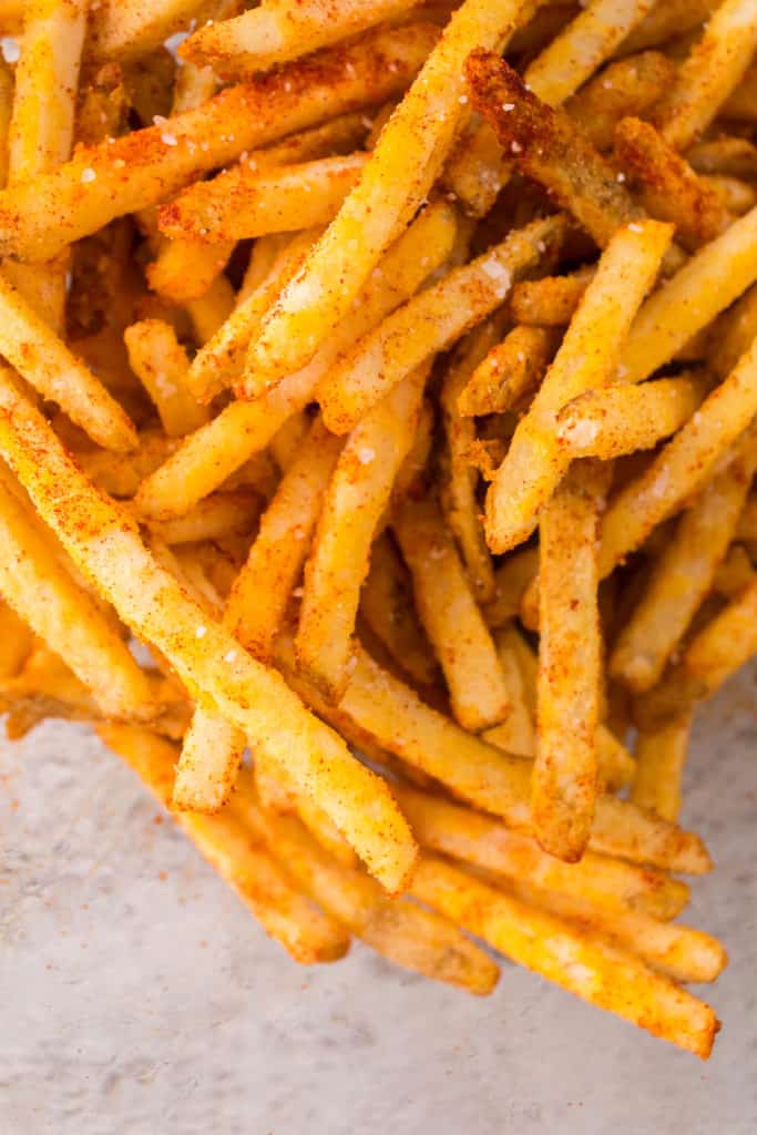 overhead closeup: air fryer checkers fries with seasonings showing