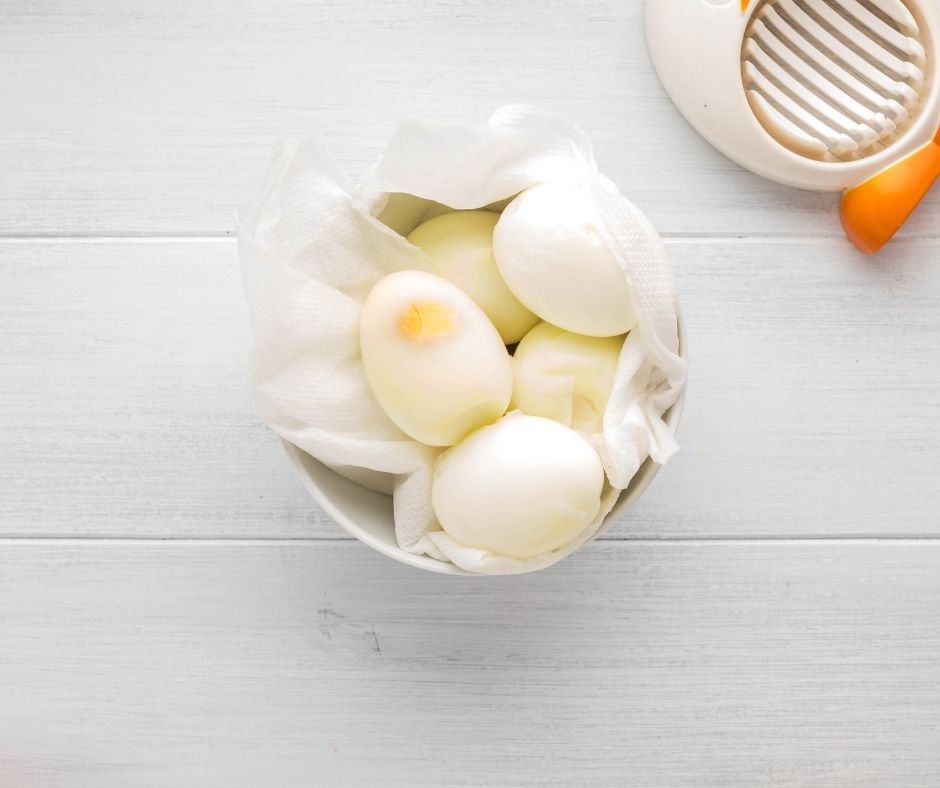 overhead: air fryer hard boiled eggs in a bowl with paper towel