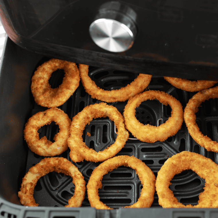 overhead closeup: frozen onion rings in air fryer basket