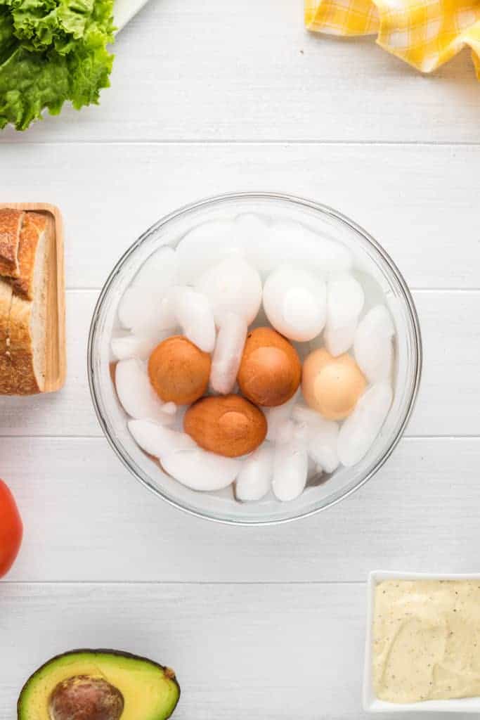 overhead: hard boiled eggs in an air fryer in an ice bath