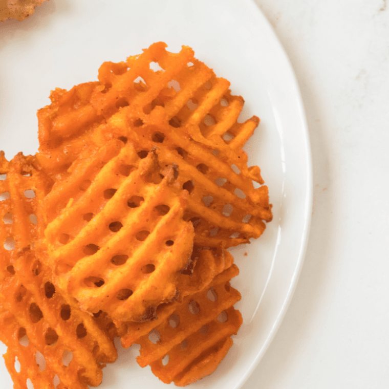 overhead closeup: air fried sweet potato waffle fries on a plate