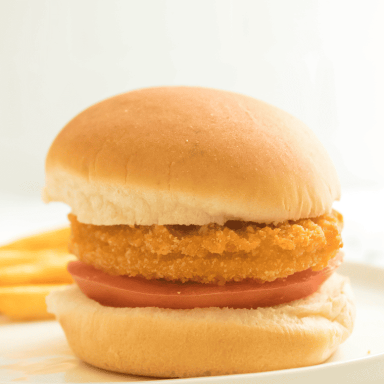 side view: tyson chicken patties air fryer recipe with tomato on a bun