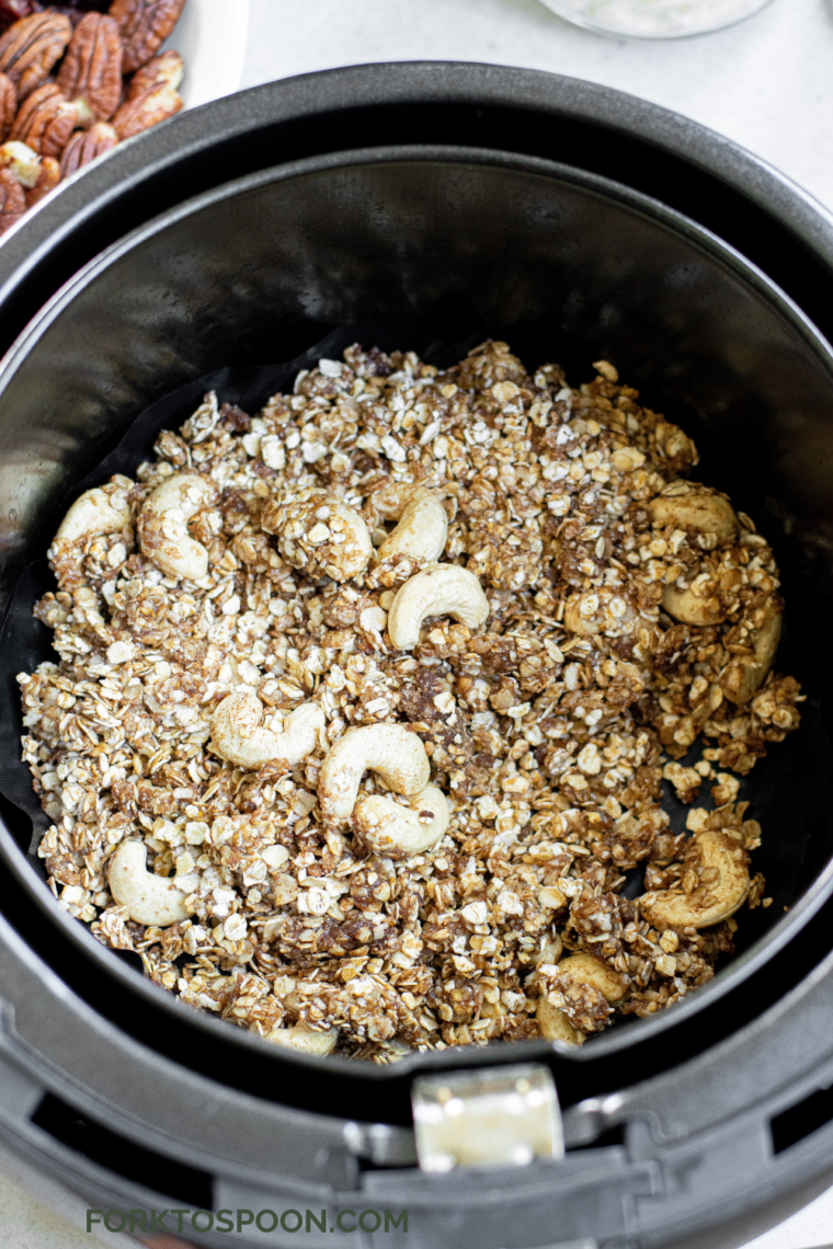 Muesli in the air fryer basket, in a single layer, about ready to be air-fried