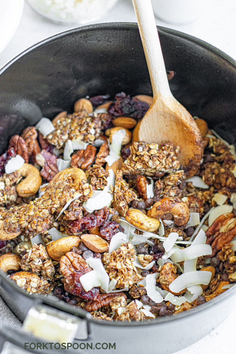 Cooked Muesli being stirred with a wooden spoon