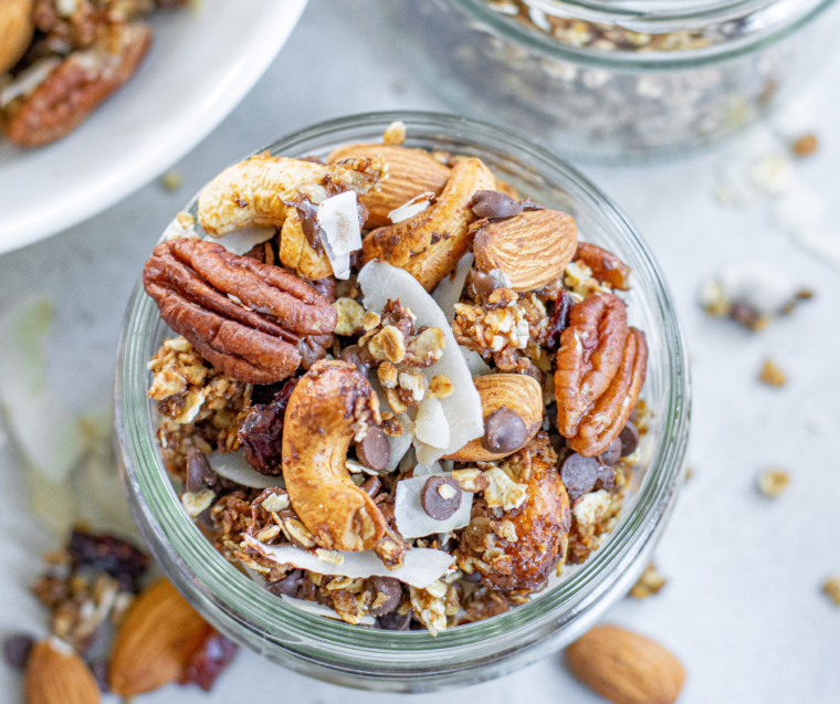 Overhead shoot of Muesli cooked, and being stored in a mason jar