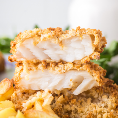 Close-up of copycat Golden Corral baked fish with lemon butter and fresh parsley