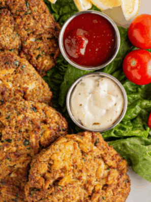 Bowl of homemade Outback Steakhouse remoulade sauce with spoon, surrounded by dipping ingredients.