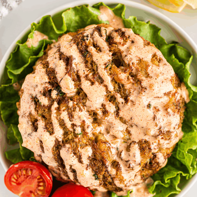 Bowl of creamy Outback Steakhouse remoulade sauce served with shrimp and lemon wedges.