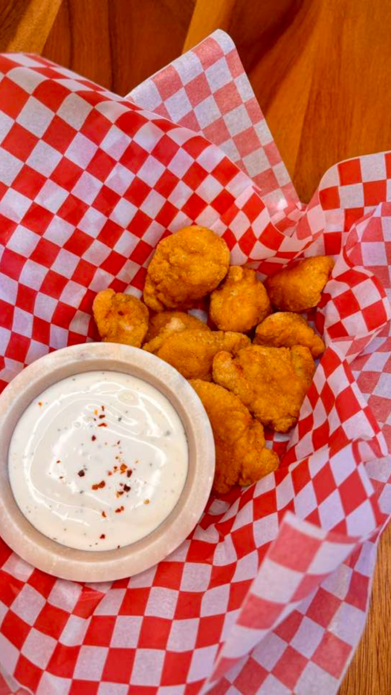 Frozen Chicken Wings Breaded in basket with sauce