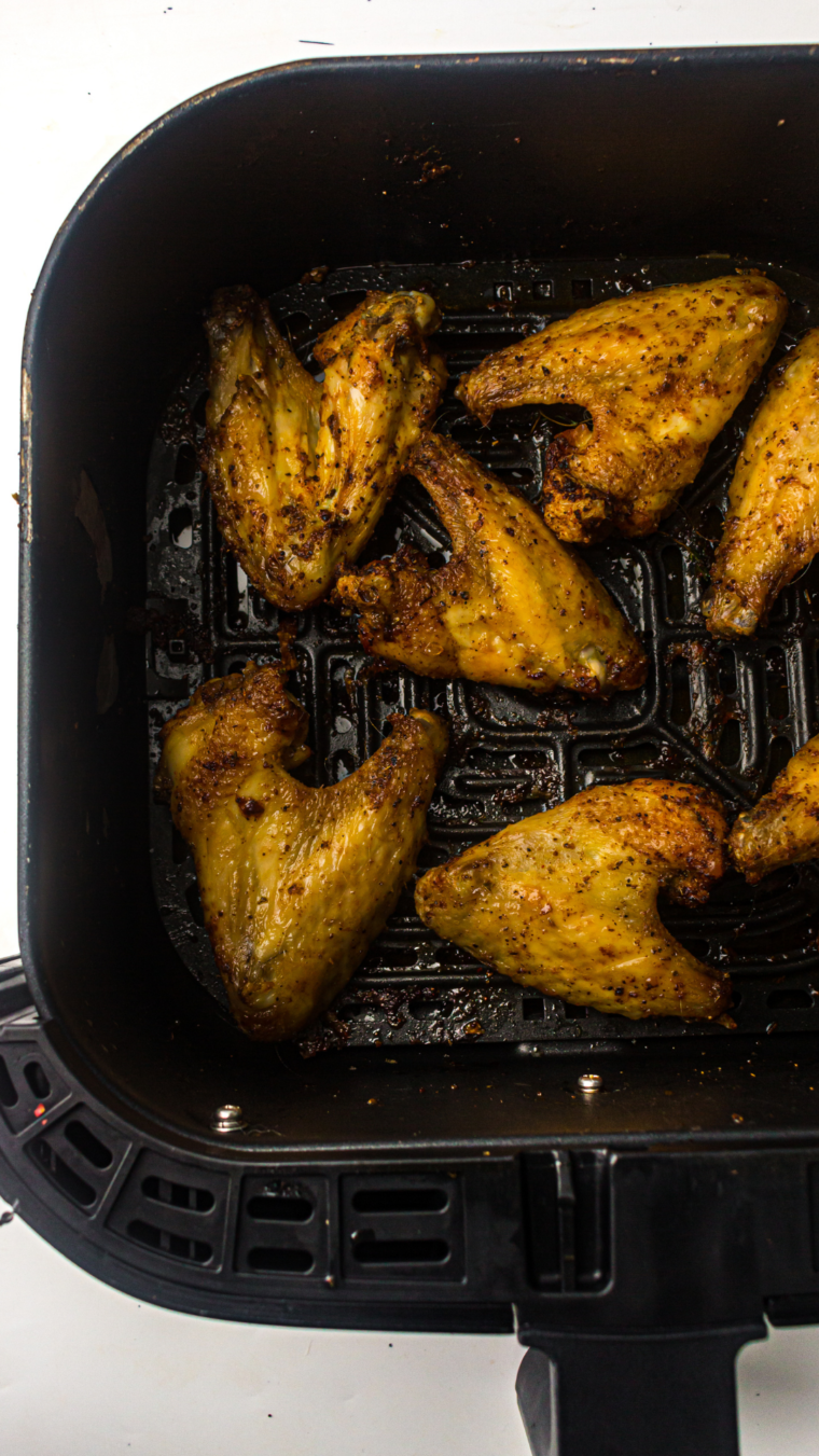 Cooked Seasoned Steakhouse Wings in air fryer basket