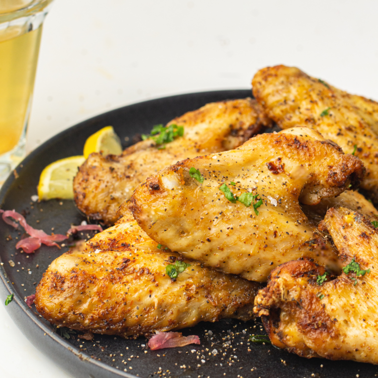 Plate of steakhouse seasoned chicken wings on a plate