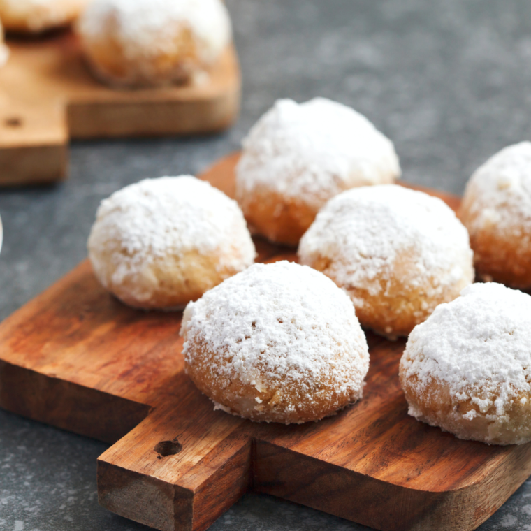 Plate of Air Fryer Snowball Cookies on cutting board.