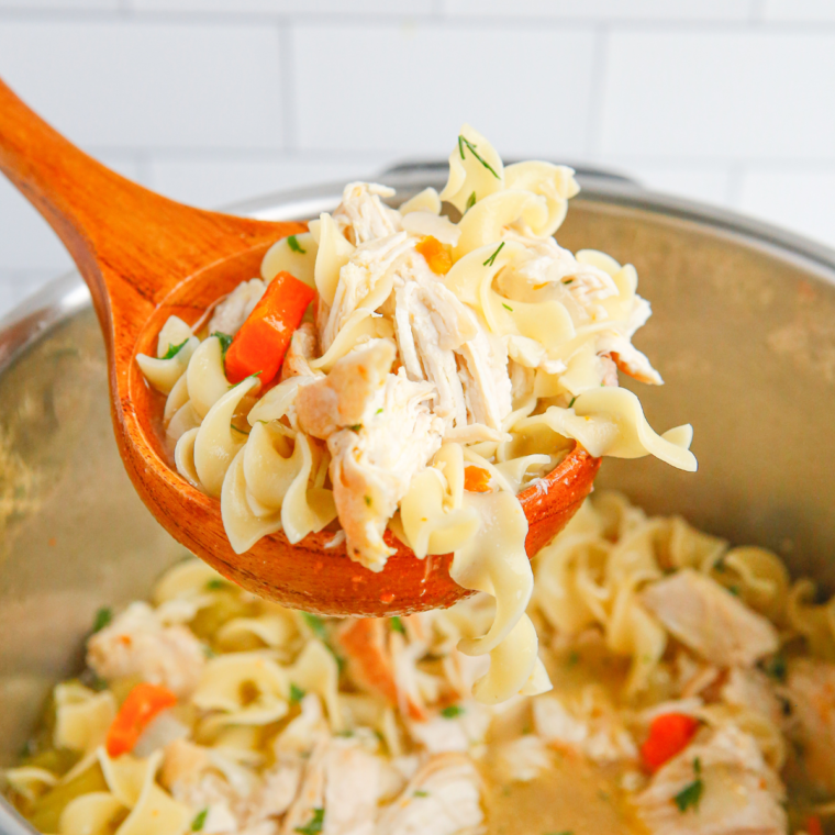 "A person stirring soup in the Instant Pot after reheating"