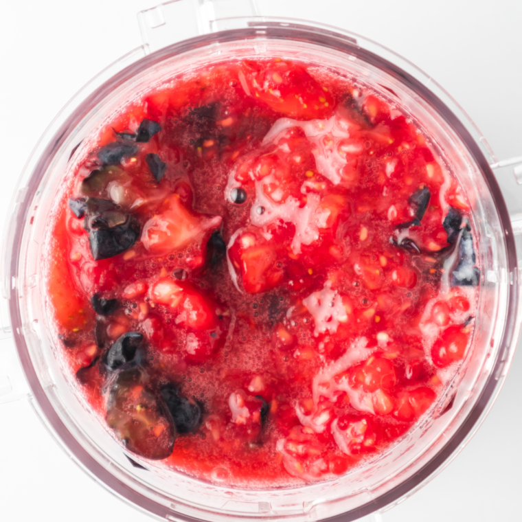 "Mashed berries in the Ninja Creami pint container, ready for making sorbet."