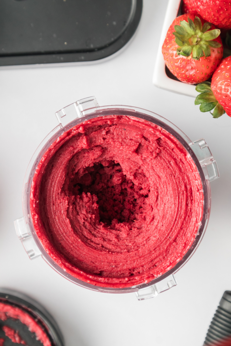 Close-up of Ninja Creami Mixed Berry Sorbet in a Ninja Creami container, showcasing the vibrant, creamy texture of the sorbet.