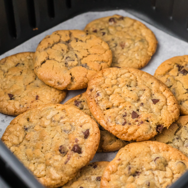 Freshly baked Air Fryer Toll House Cookies with gooey chocolate chips on a cooling rack.