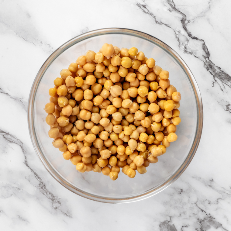 Ingredients needed for Air Fryer Chickpeas No Oil on a marble table.