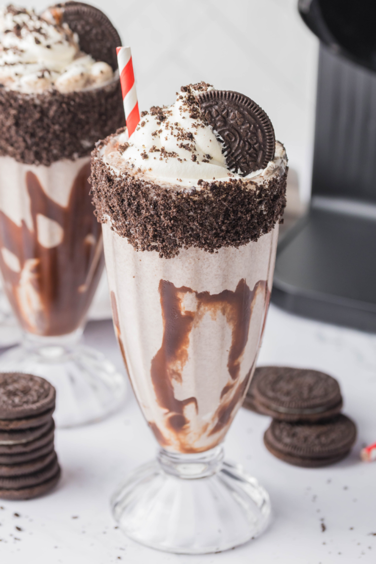 Creamy chocolate milkshake topped with crushed Oreos and whipped cream.