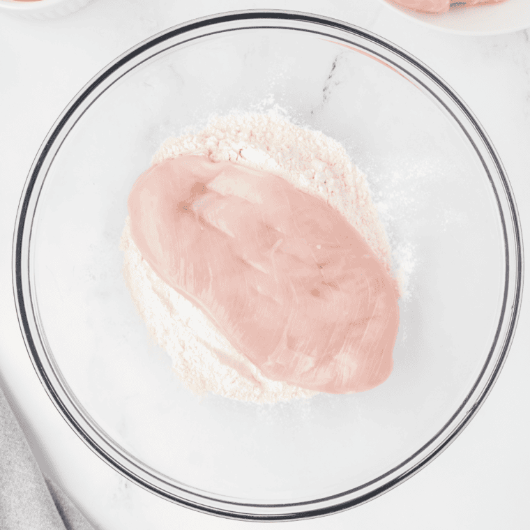 Chicken in a bowl with flour