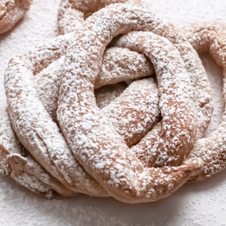 Close-up of a crispy, golden funnel cake cooked in the air fryer, highlighting its airy texture and delicious detail.