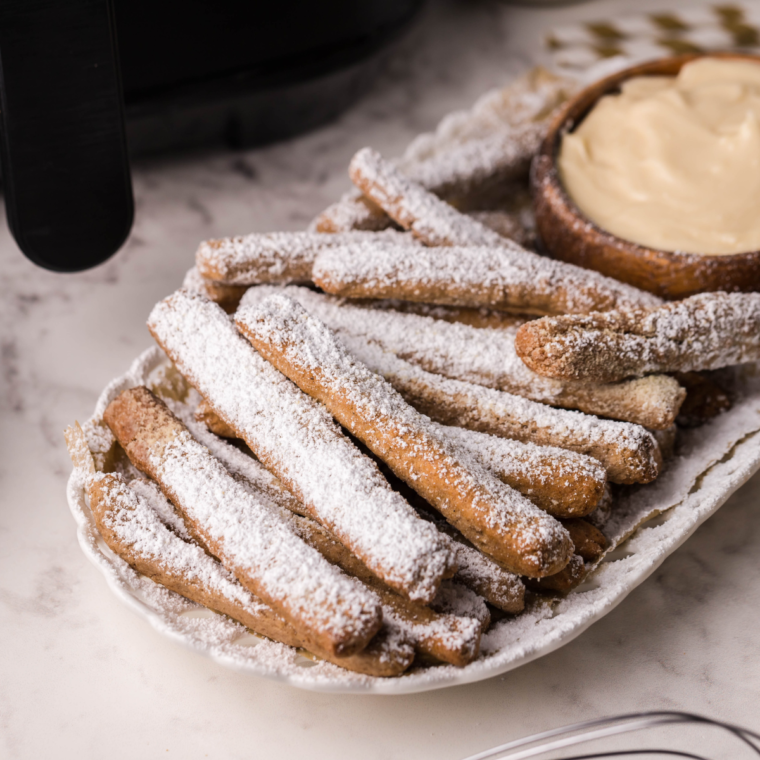 Air fryer displaying funnel cakes inside for reheating, emphasizing their crispy texture.