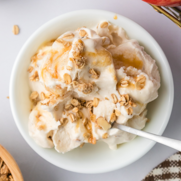 "Plate of creamy Ninja Creami Apple Cobbler Ice Cream topped with caramel drizzle and cinnamon, capturing the essence of fall desserts.