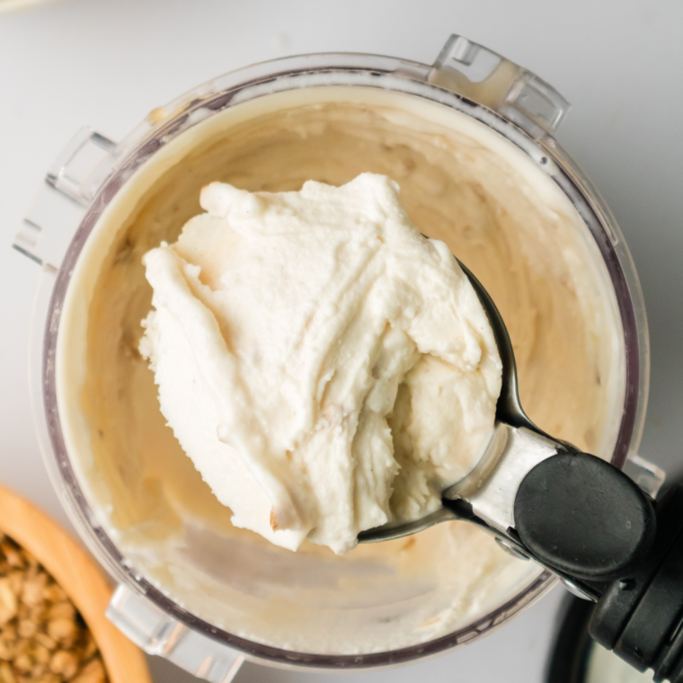 A bowl of creamy Ninja Creami Apple Cobbler Ice Cream topped with crumbled cobbler and a sprinkle of cinnamon, showcasing its rich apple flavor and creamy texture.