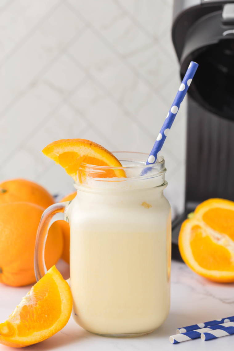 Ninja Creami Orange Julius in a glass with a straw