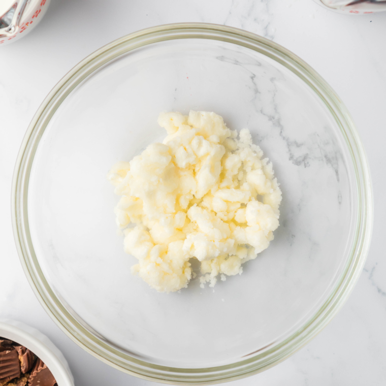 Adding sugar and vanilla extract to the cream cheese mixture.