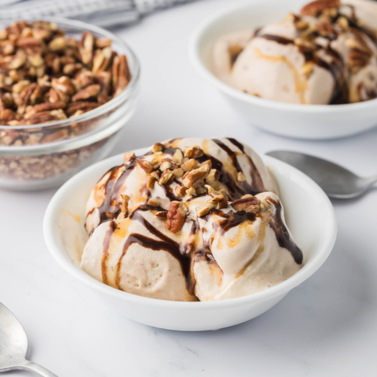 Close-up of a creamy Ninja Creami Turtle Pecan Cluster Blizzard with caramel swirls and crunchy pecans.