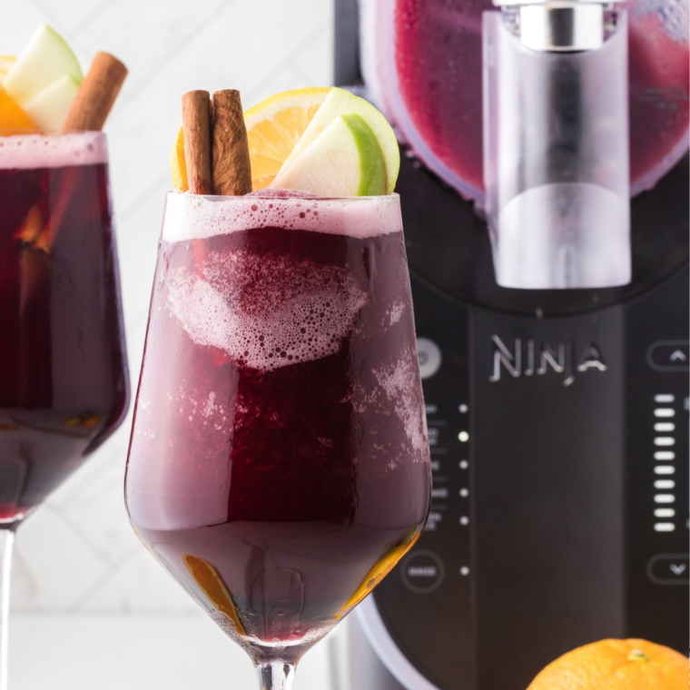 Refreshing Sangria Wine Slushie garnished with orange slices and berries