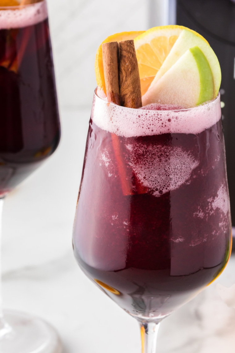 "Close-up of Ninja Slushi Sangria Wine Slushie in a glass garnished with fresh fruit"