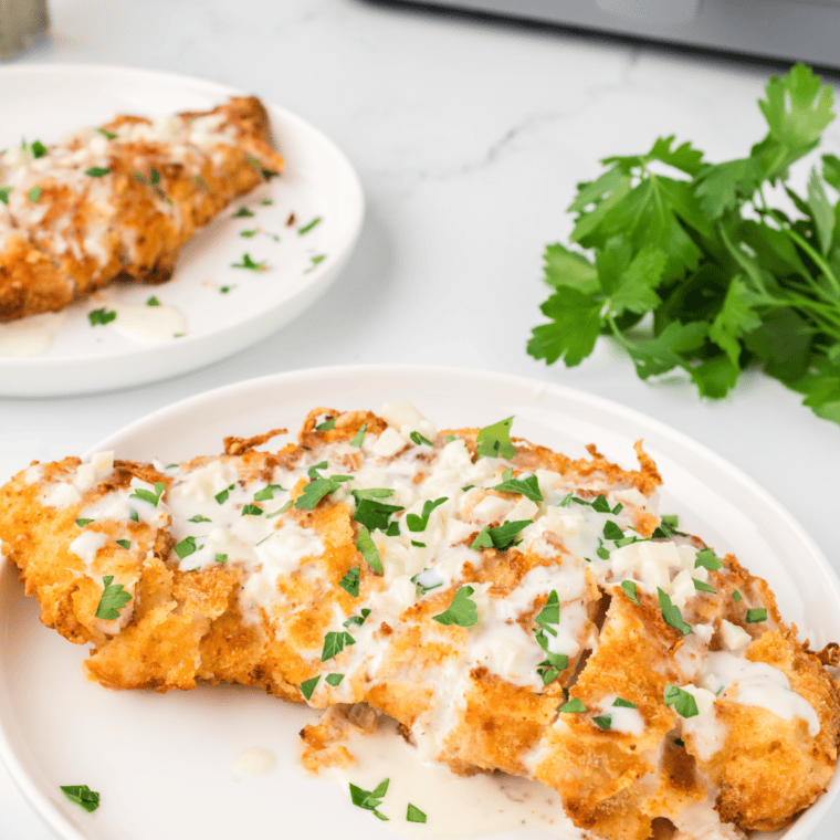 Air fryer Crispy Chicken Fritta, topped with sauce and herbs