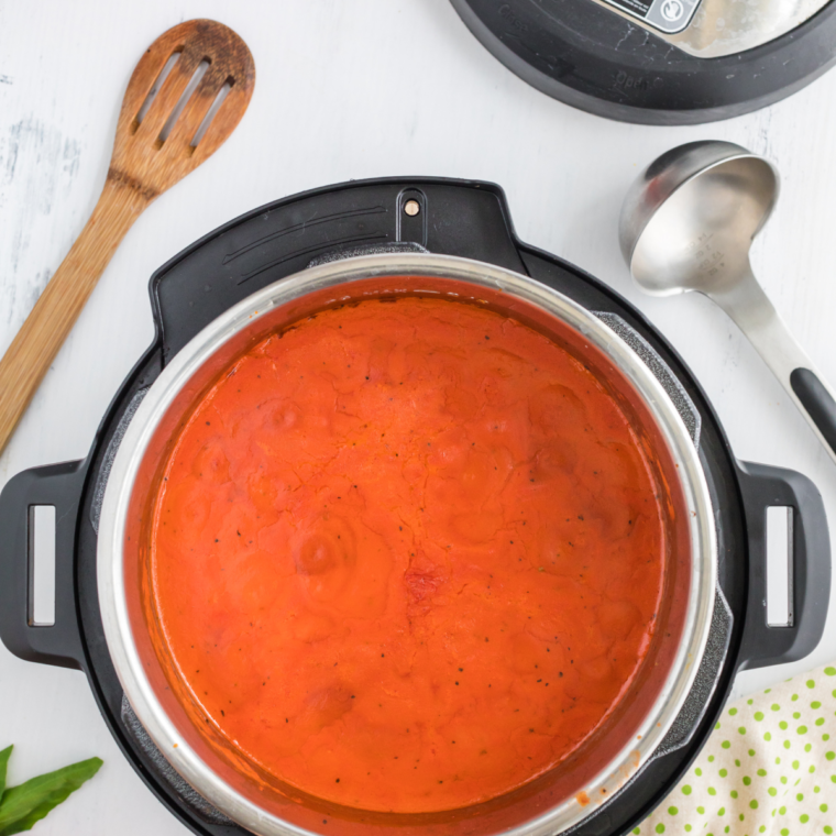 Blending the soup until smooth using an immersion blender.