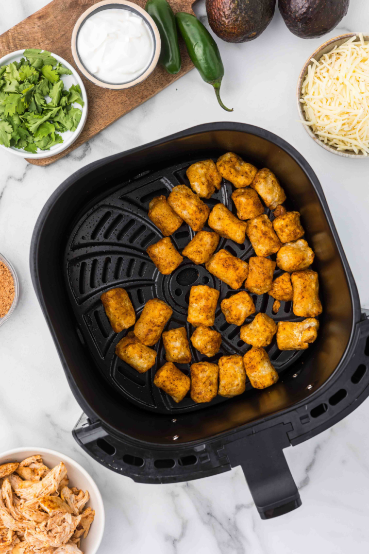 Trader Joe's Cauliflower Gnocchi in an air fryer basket.