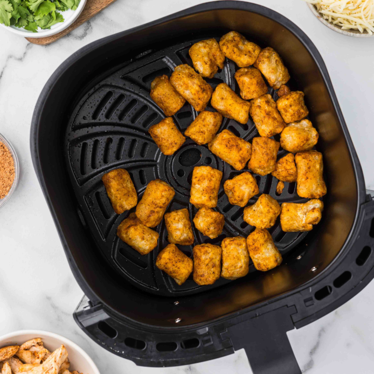 Crispy, golden brown air-fried cauliflower gnocchi fresh from the air fryer.