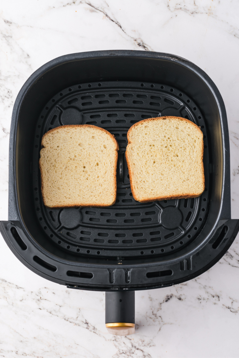 Place the bread into the air fryer basket, providing a great crunch, for the bottom layer.