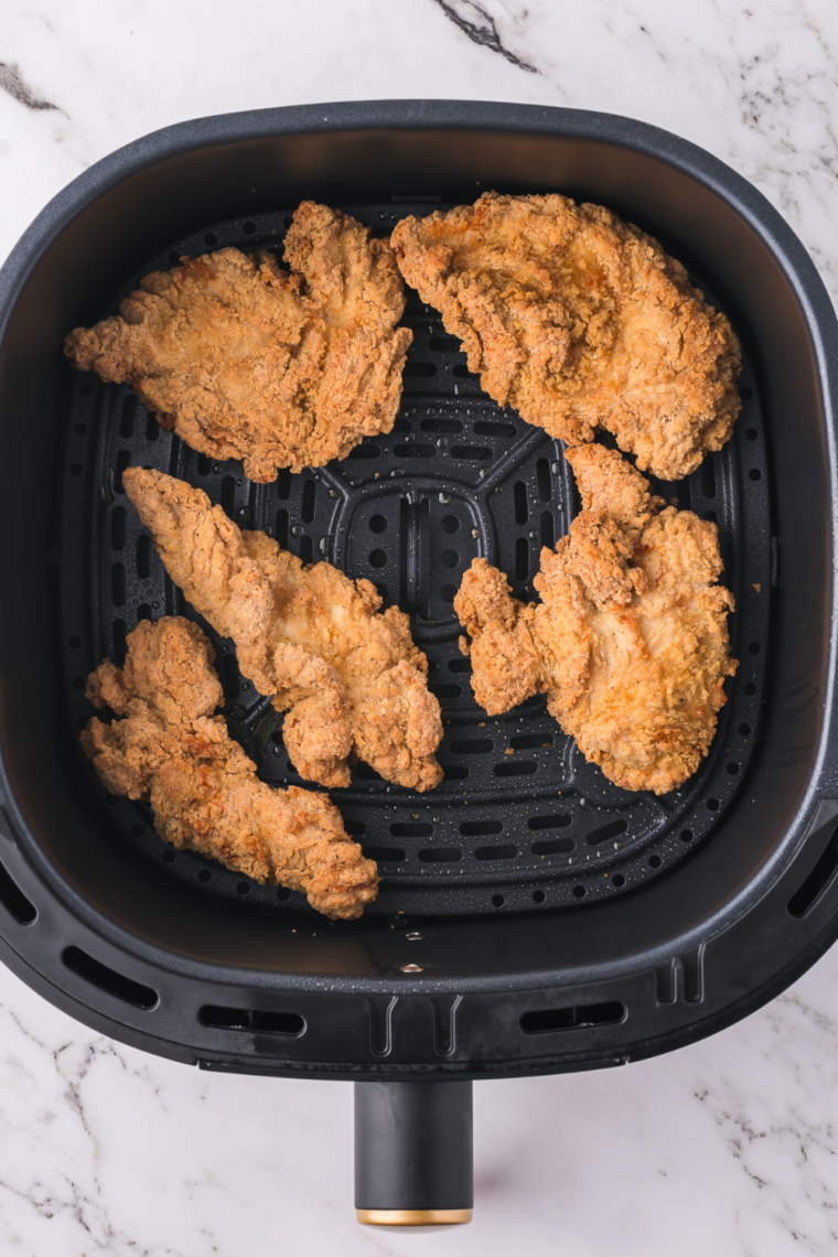 Slice crispy chicken tenders into strips for wraps.