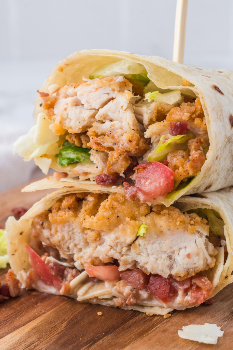 Close-up of golden Air Fryer Chicken Caesar Wrap with bacon bits.