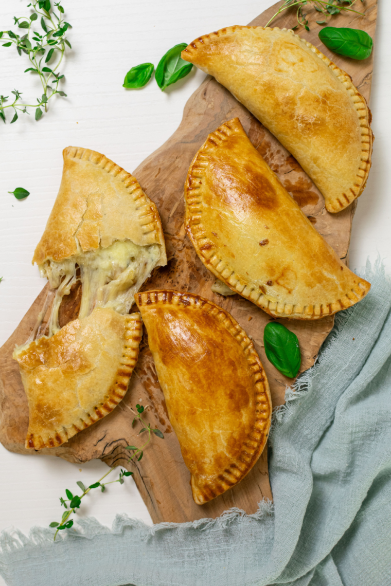 Air Fryer Cheese and Onion Pasty on a plate, with a savory cheese and onion filling.